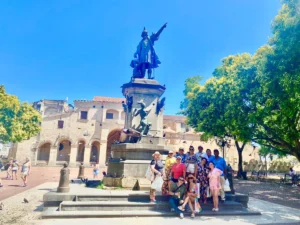 Turistas posando para fotos en el Parque Colón, zona colonial de Santo Domingo